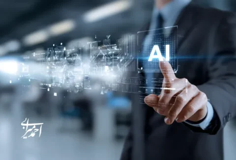 مدیر تجاری با لباس رسمی در حال لمس آیکون هوش مصنوعی (AI) روی صفحه‌ی شفاف دیجیتال در محیط اداری مدرن، نماد تحول کسب‌وکار با فناوری هوش مصنوعی — دکتر احمد میرابی