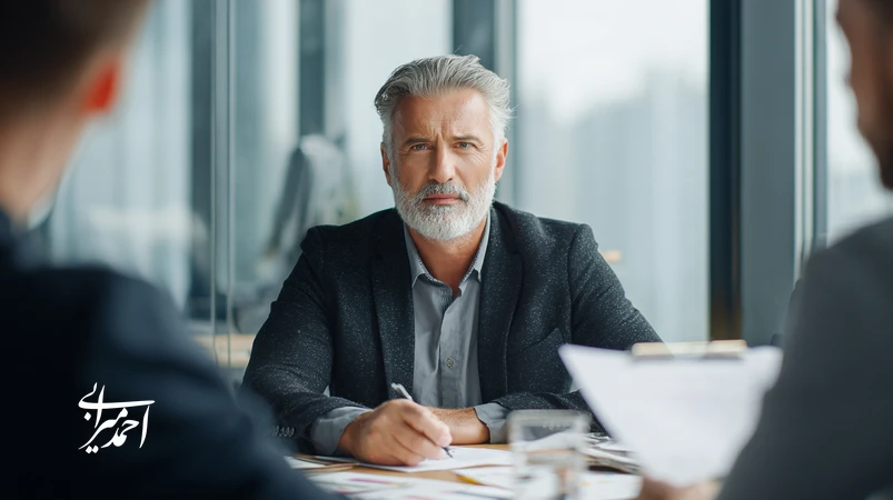 Iranian manager in a business meeting comparing coaching and mentoring approaches for managerial development and higher productivity